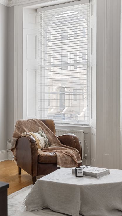 Armchair by a tall sash window